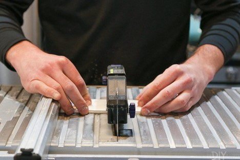 Cutting tiles with a wet saw.